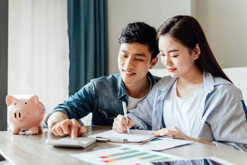 young couple sitting at table budgetting