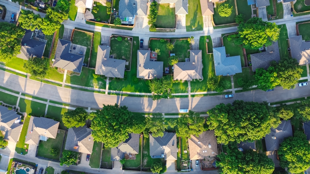 Aerial view of rows of residential homes lining a suburban street.