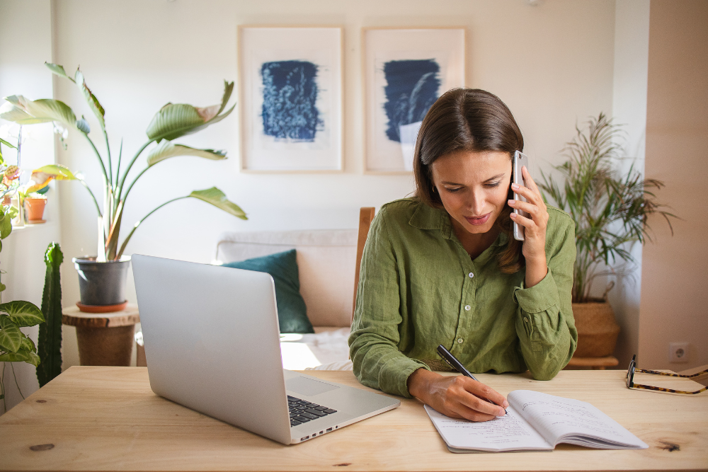 Woman on the phone with her home insurance agent discussing credit history.