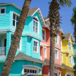 colorful Florida beach homes nestled by row of palm trees