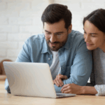 Young couple researches ways to save on their homeowners insurance
