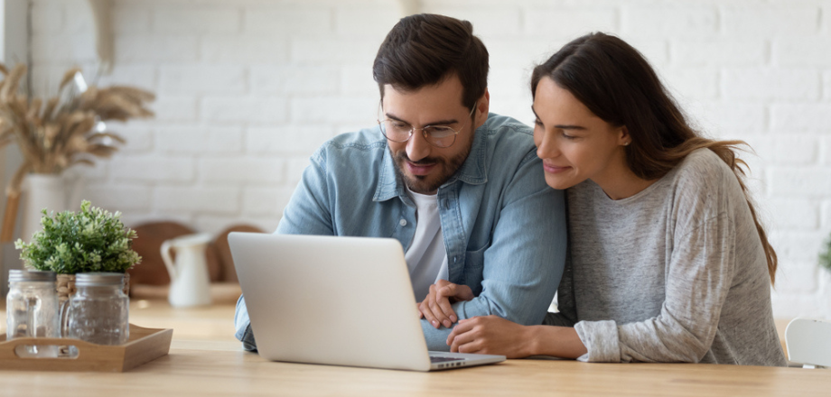 Young couple researches ways to save on their homeowners insurance