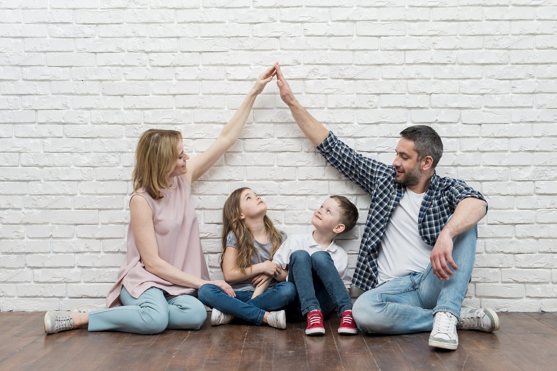 mother and father sitting with kids