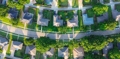 Aerial view of rows of residential homes lining a suburban street.