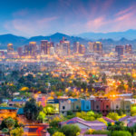 Downtown Phoenix, AZ, skyline with mountains shown at sunset.