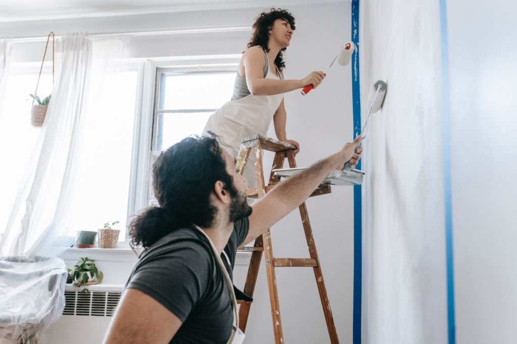 couple painting a room in a house