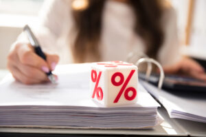 woman filling out paperwork with interest rates