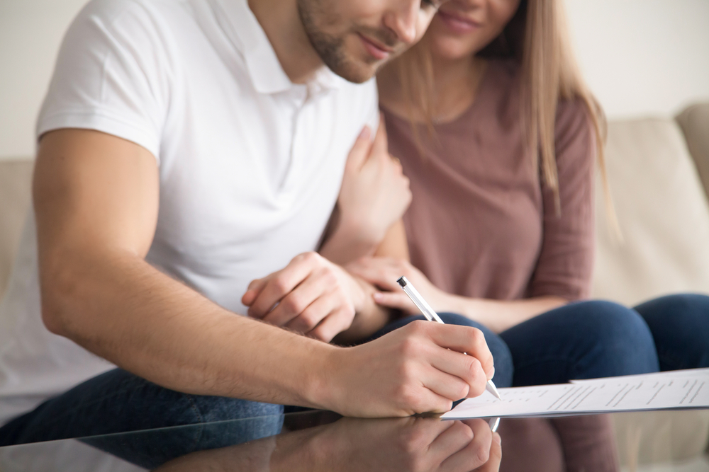 New home buying couple purchases their home through an embedded insurance partnership.