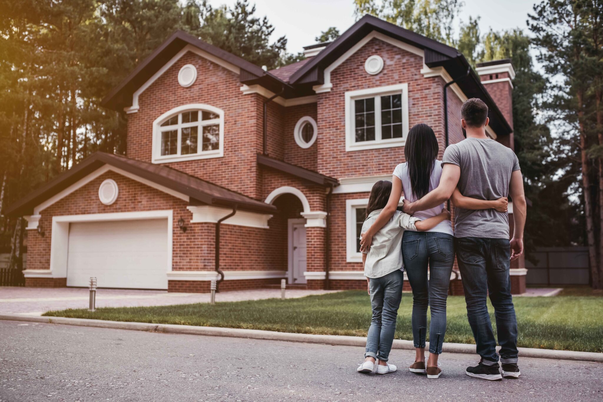 family in front of home