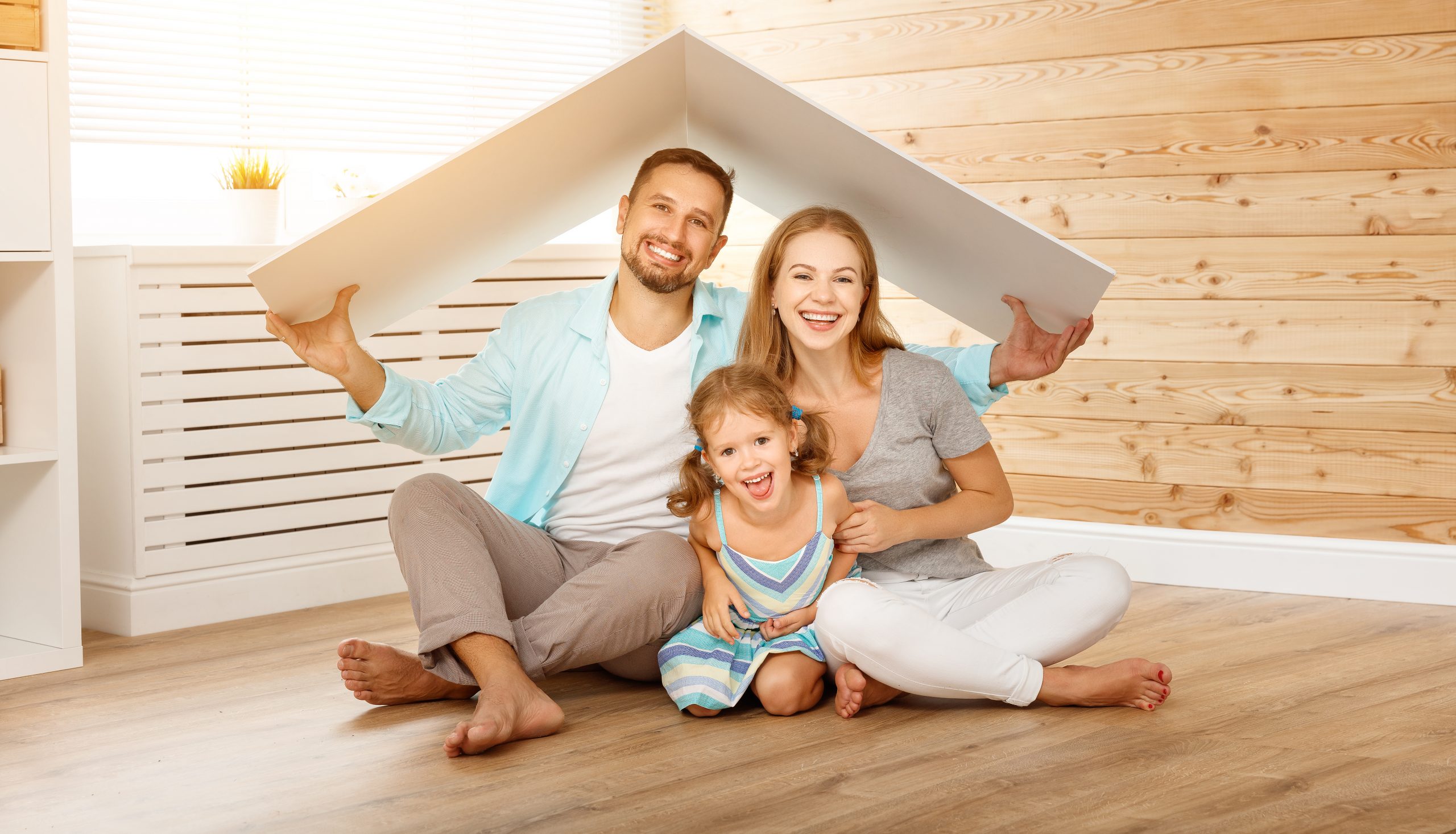 Happy family in a new home. Mom, dad and daughter