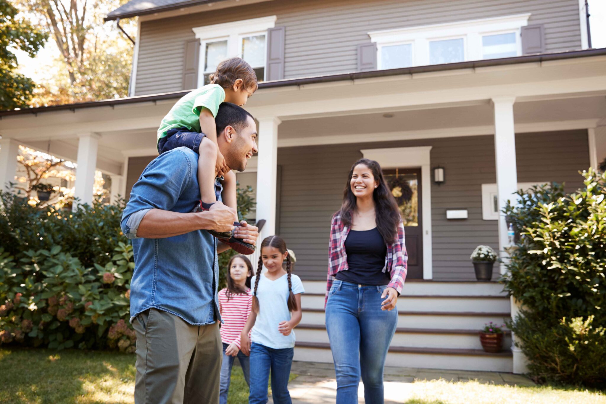 family in front of house